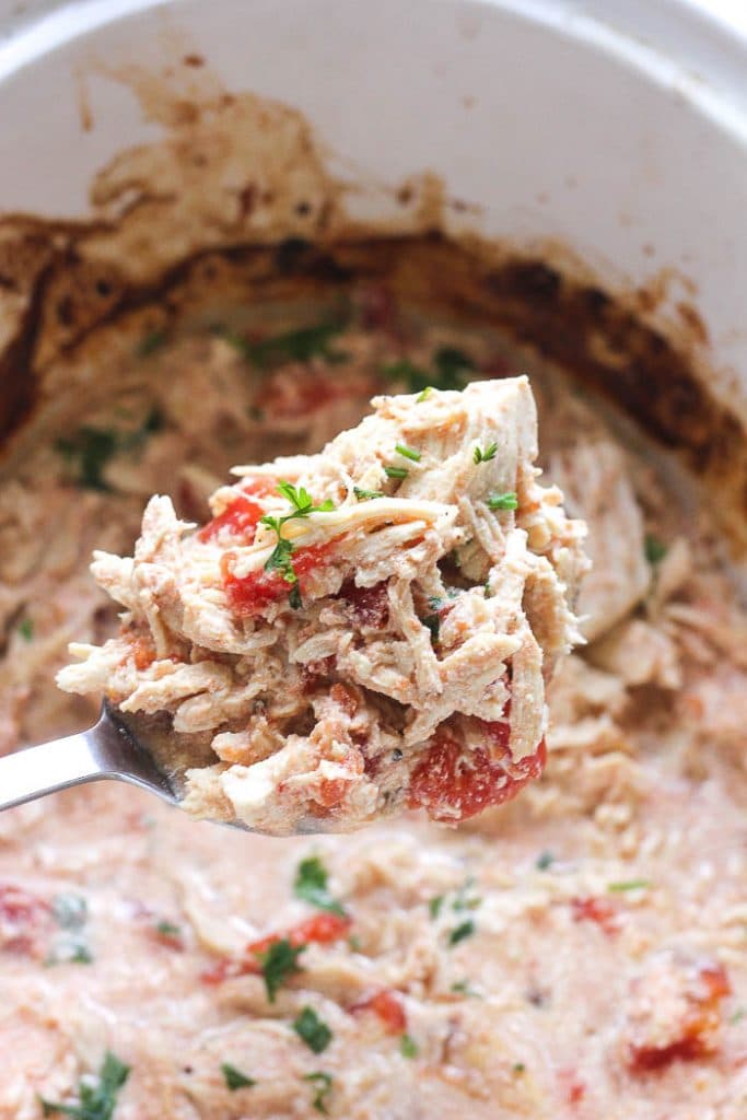 shredded chicken in the spoon in slow cooker