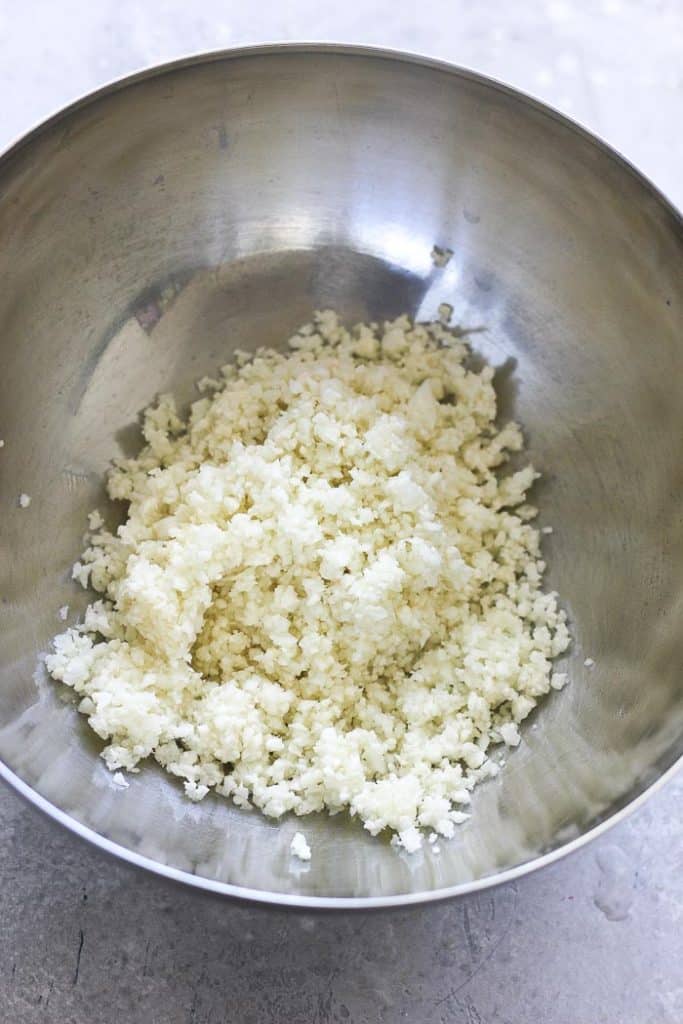 a bowl of raw cauliflower rice