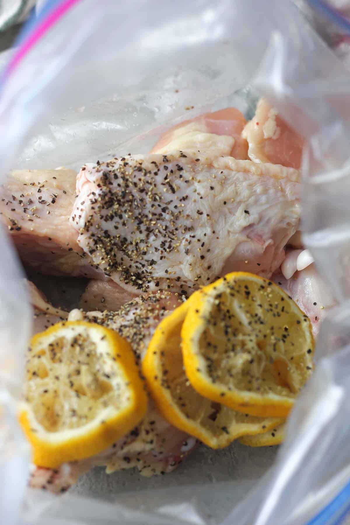 wings marinating in the zip lock bag with lemon and spices