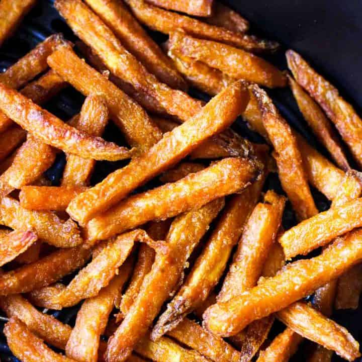 cooked crispy fries in black air fryer basket