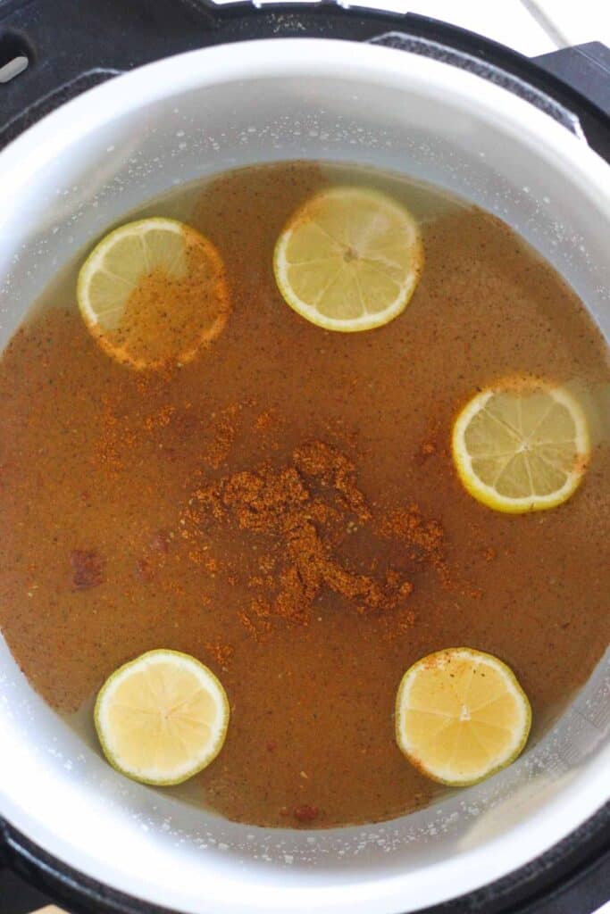 chicken broth with spices and lemons in ninja foodi inner pot