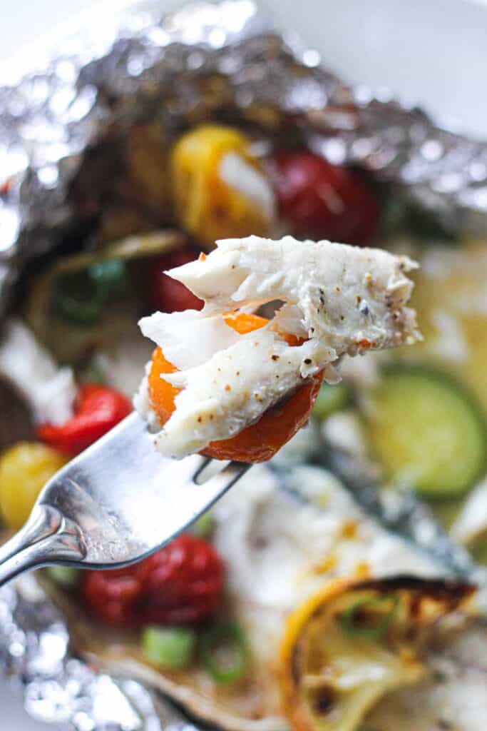 a piece of baked branzino on a fork