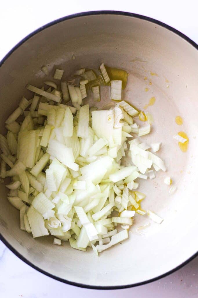 sauteing chopped onions in a heavy bottom pan