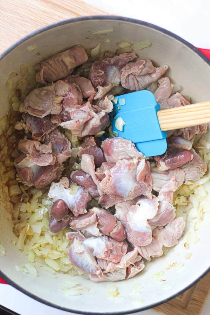 raw chicken hearts and gizzards in a pot