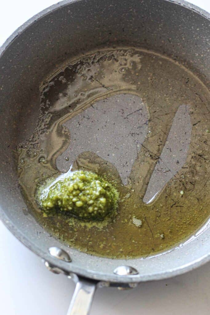 pesto in a pan with melted butter