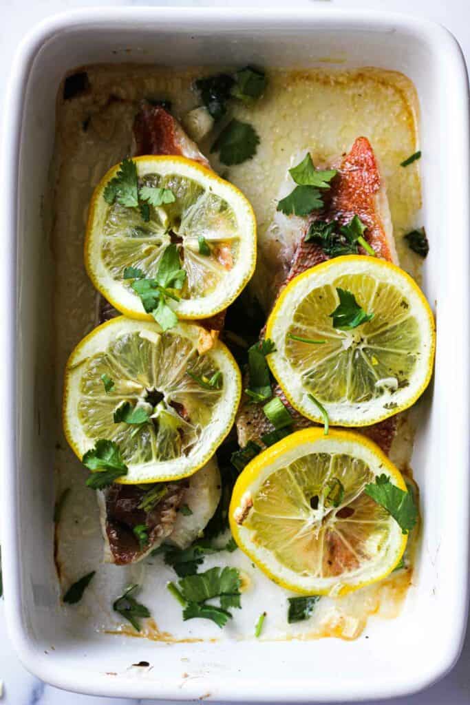 baked ocean perch with lemon, green onions and chopped cilantro