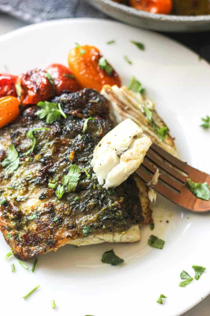 cooked barramundi fillet piece on a fork