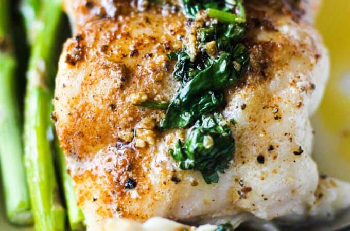 a slice of pan fried grouper fillet with asparagus