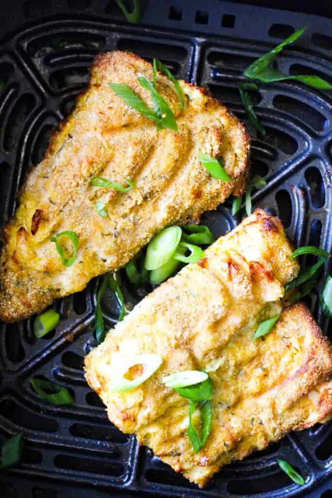 air fryer walleye fish with chopped green onions on top