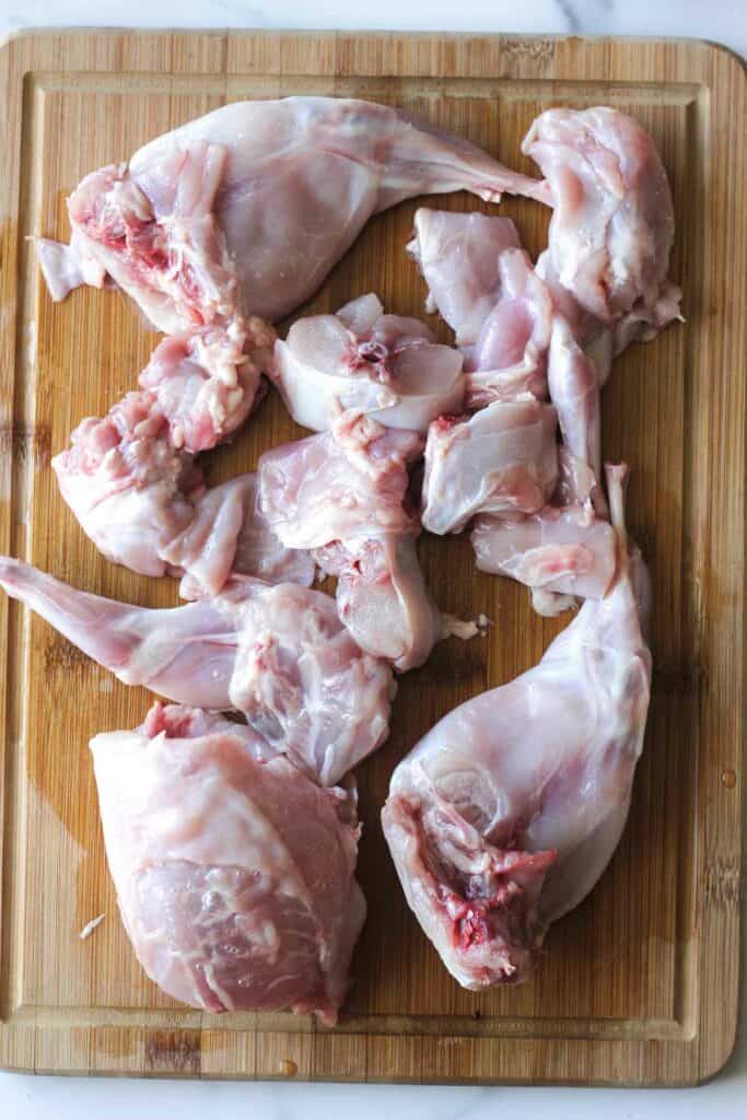 raw chopped rabbit pieces on the cutting board