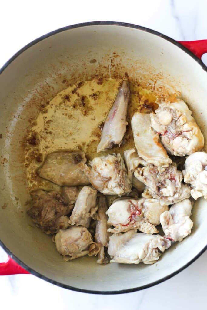 searing rabbit in oil in medium pot