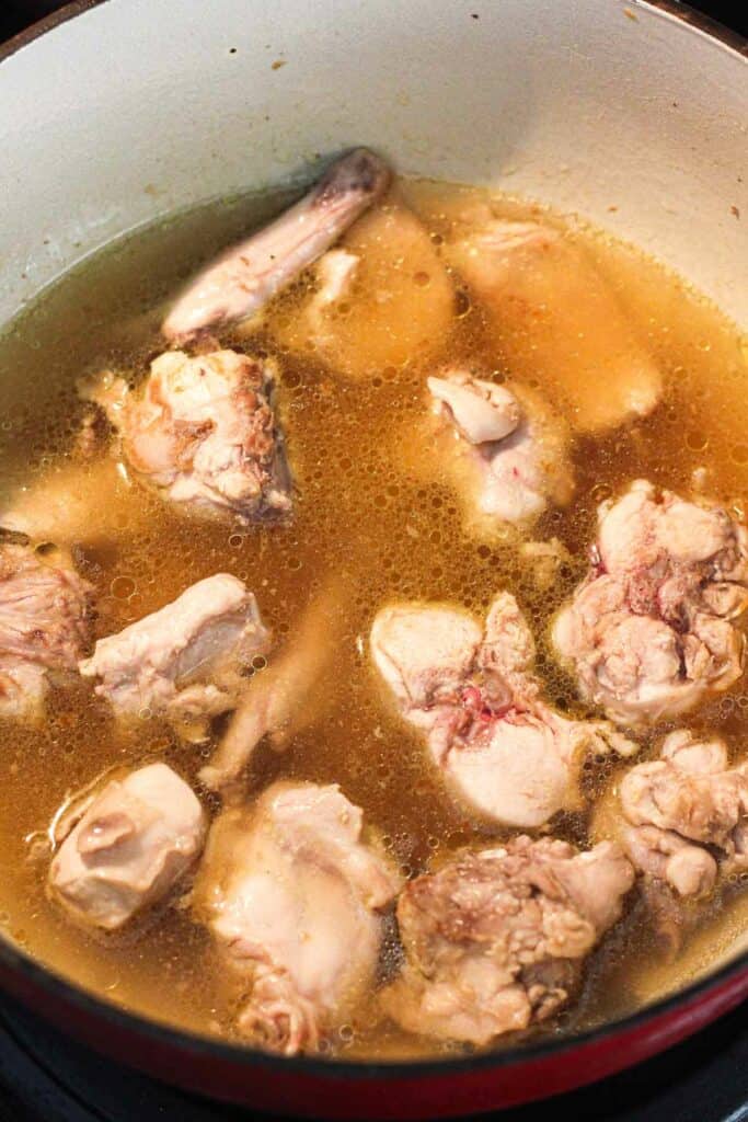 sauteing rabbit in chicken broth in pot