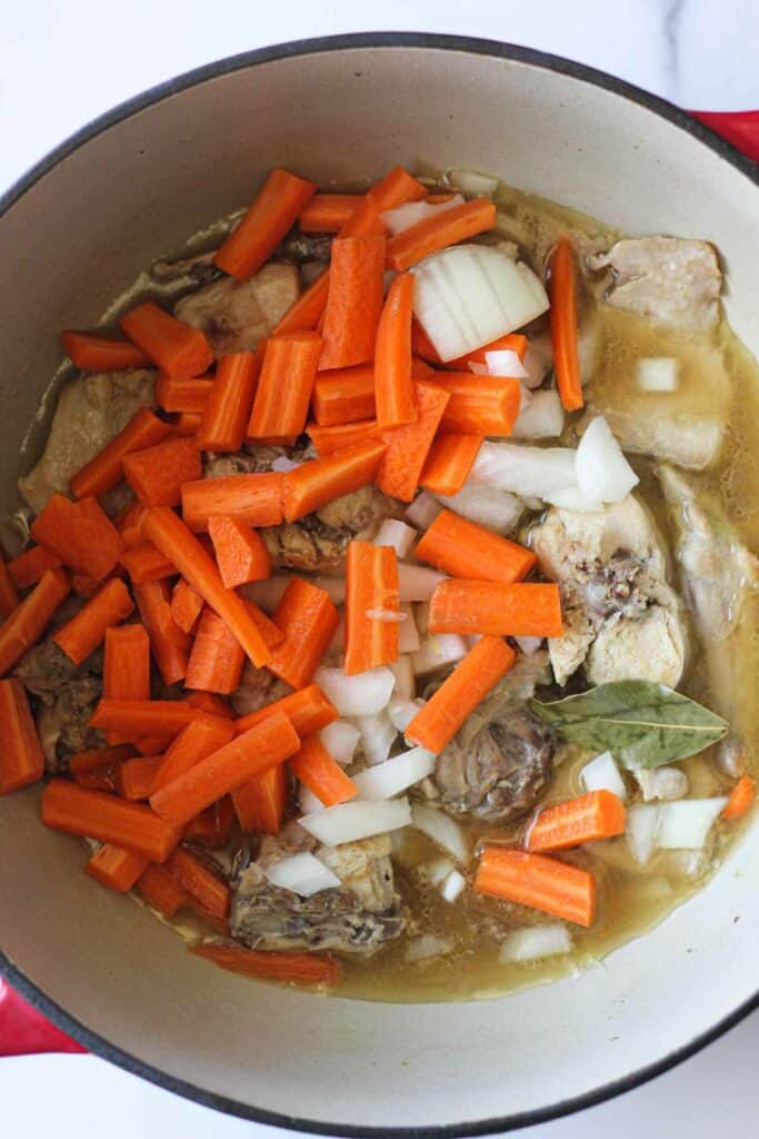 chopped carrots and onions added to rabbit stew