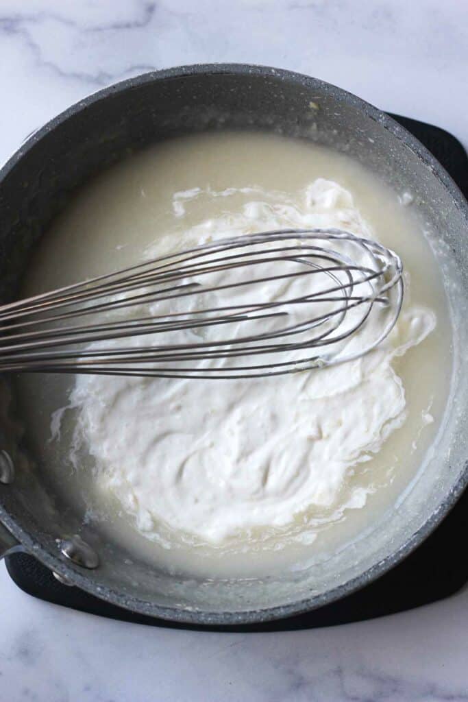 making white sour cream herb souce on the stove