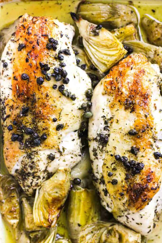 golden baked brown chicken with vegetables and capers