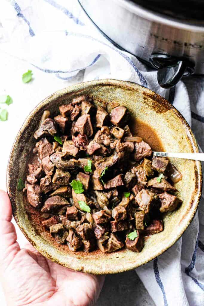 cooked cow heart in crock pot served in a bowl