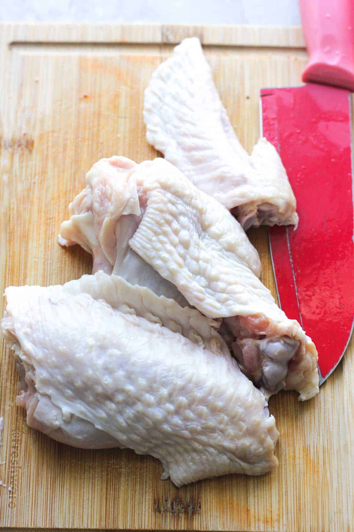 raw turkey wings on the cutting board