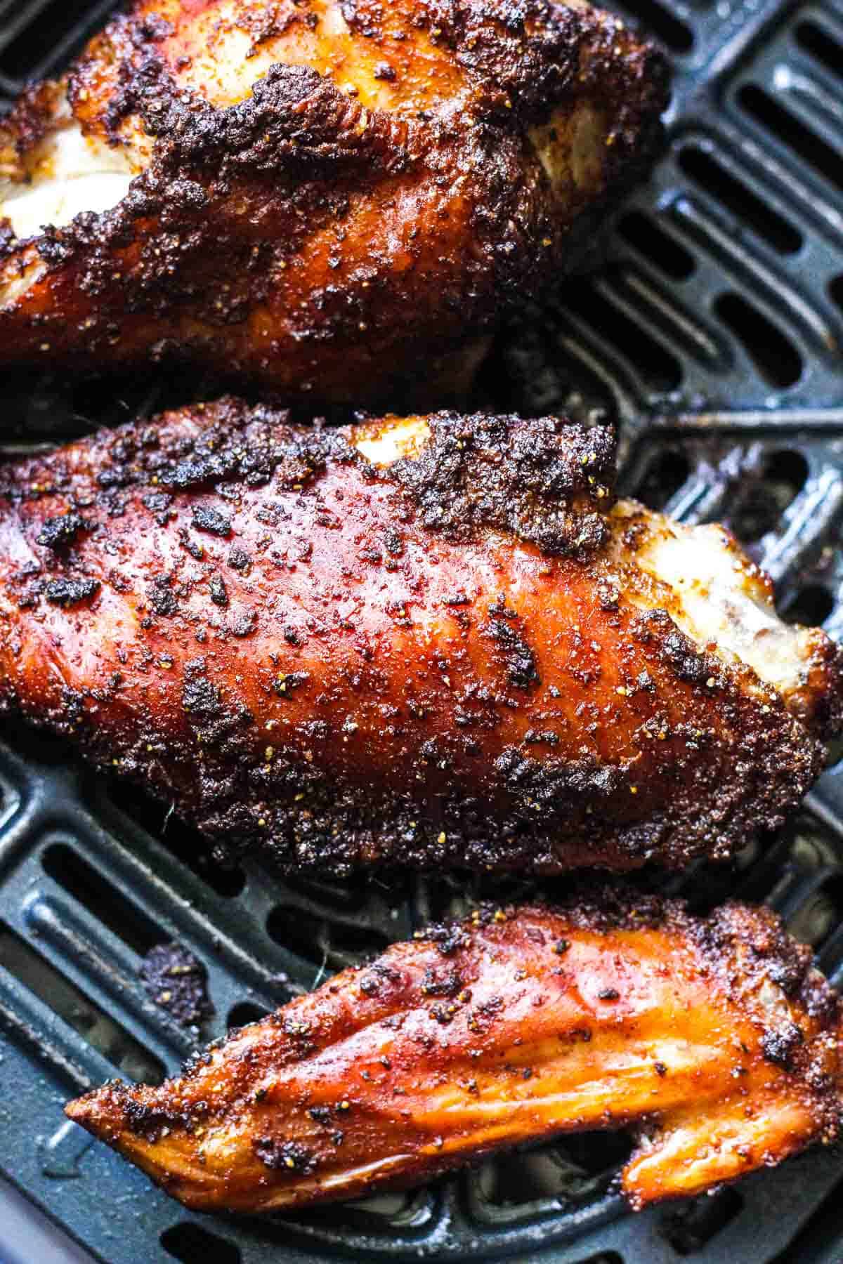 turkey wings in air fryer with dark brown skin