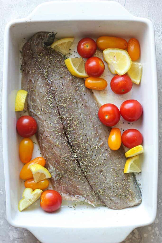 raw bluefish fillet with tomatoes