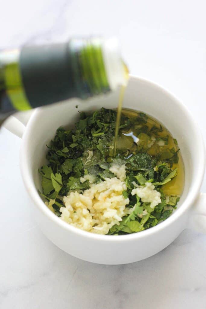 minced garlic, chopped cilantro, salt and olive oil in a mixing bowl