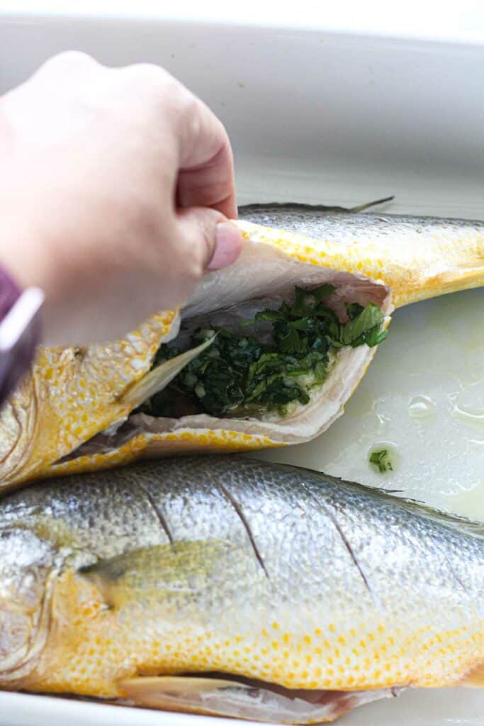 stuffing fish with cilantro mixture