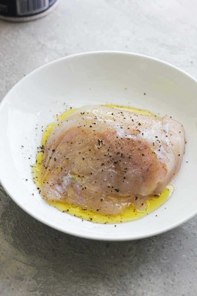 raw monk fish fillet marinating in oil with spices