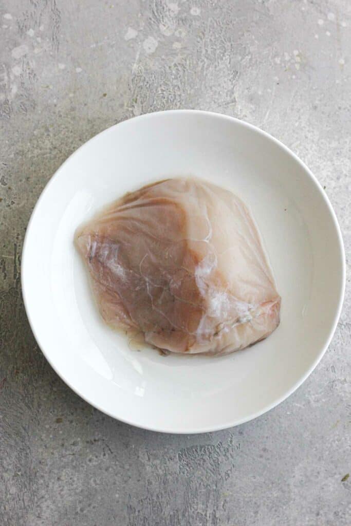 raw fish fillet on a plate before cooking