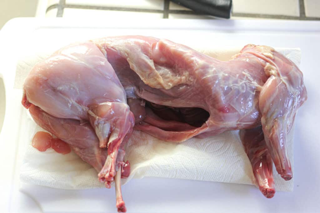 raw whole rabbit on the cutting board