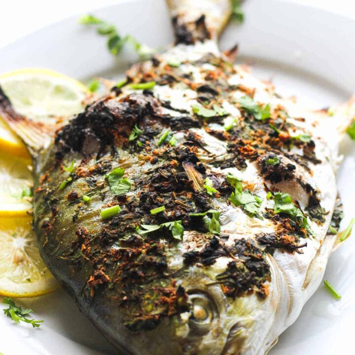 cooked pompano fish with spices and lemon