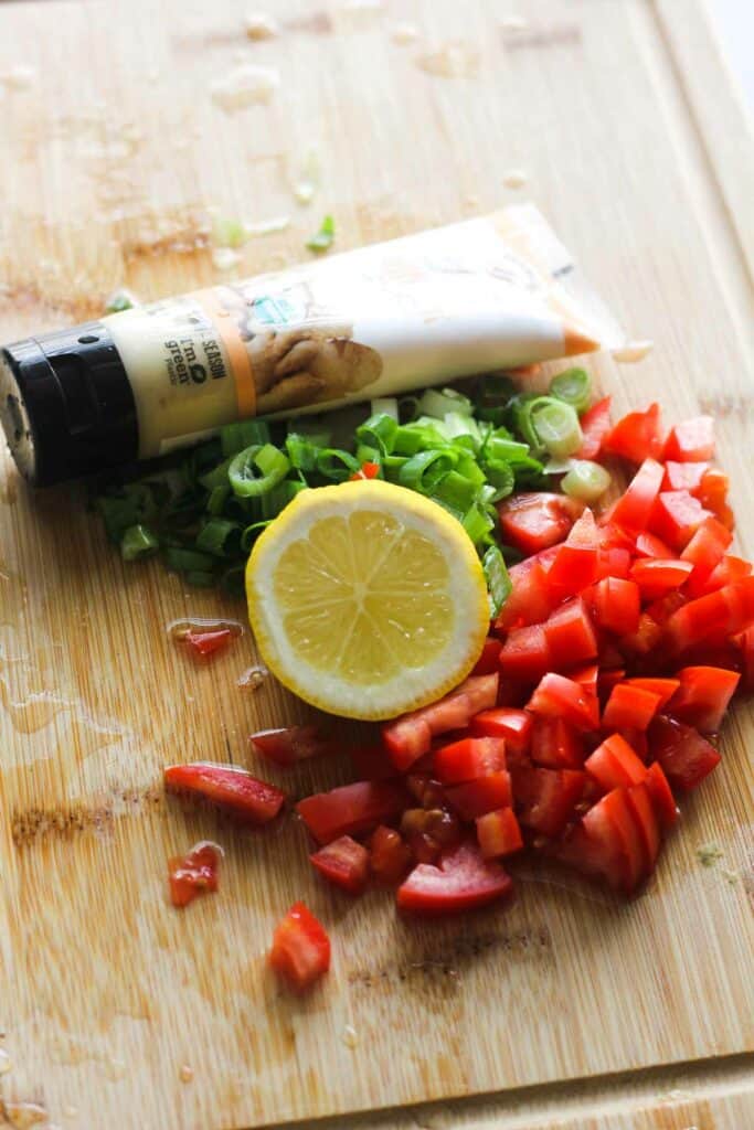 ingredients used in this recipe- ginger paste, tomatoes, lemon and green onions