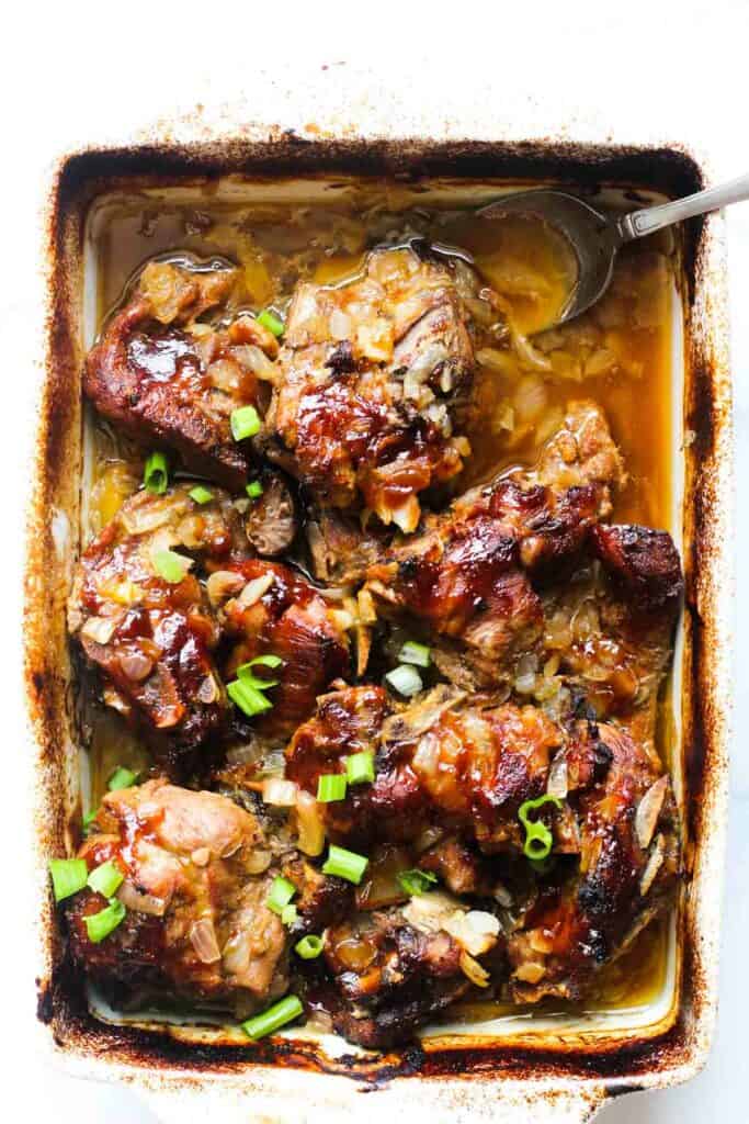 baked pork neck bones with chopped green onions on top