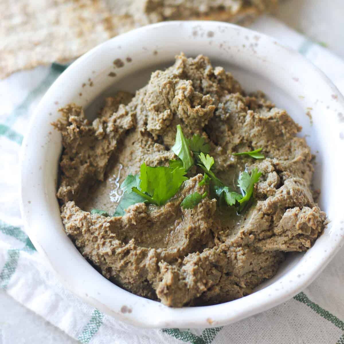 beef liver pate in a small bowl with cilantro on top