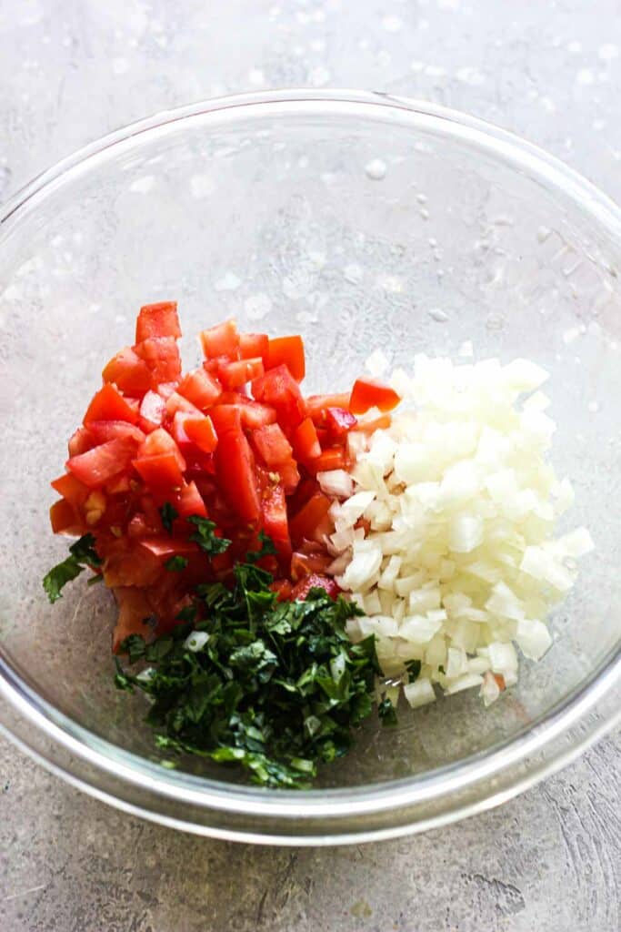 chopped tomatoes, cilantro and onion in a bowl