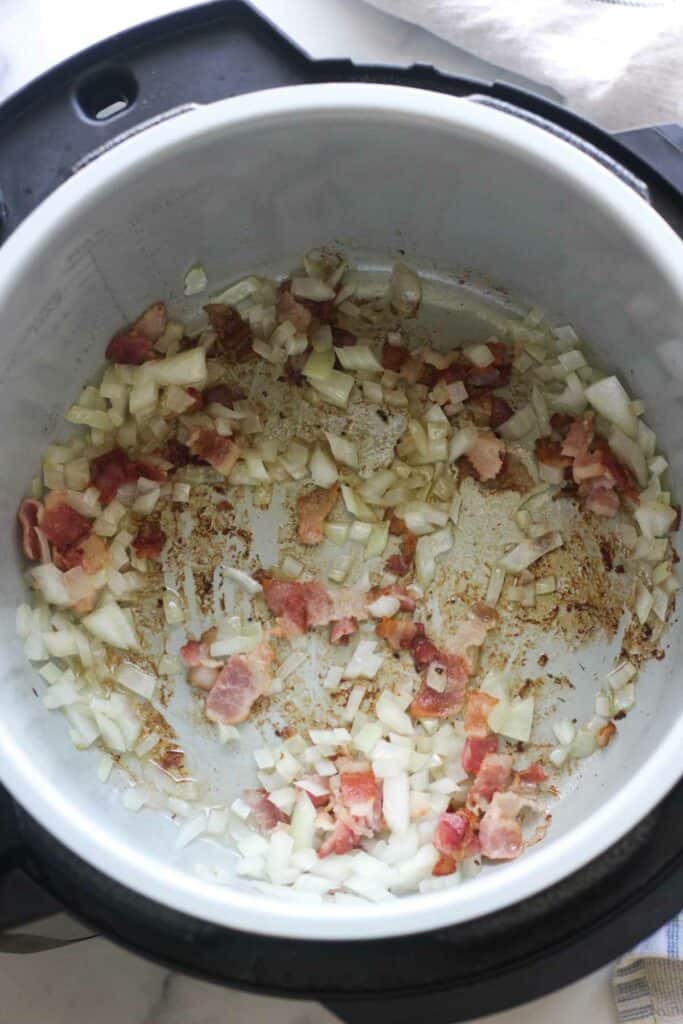sauteing chopped onion and bacon in ninja foodi inner pot