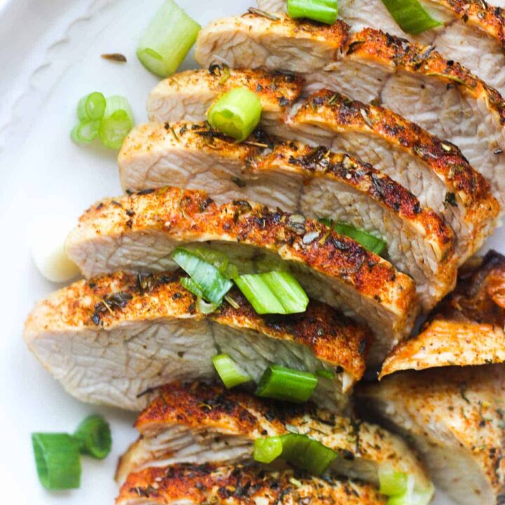 cooked turkey tenderloin with chopped green onion on top