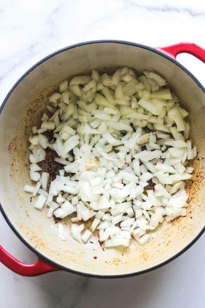 sauteing chopped onions in chorizo fat