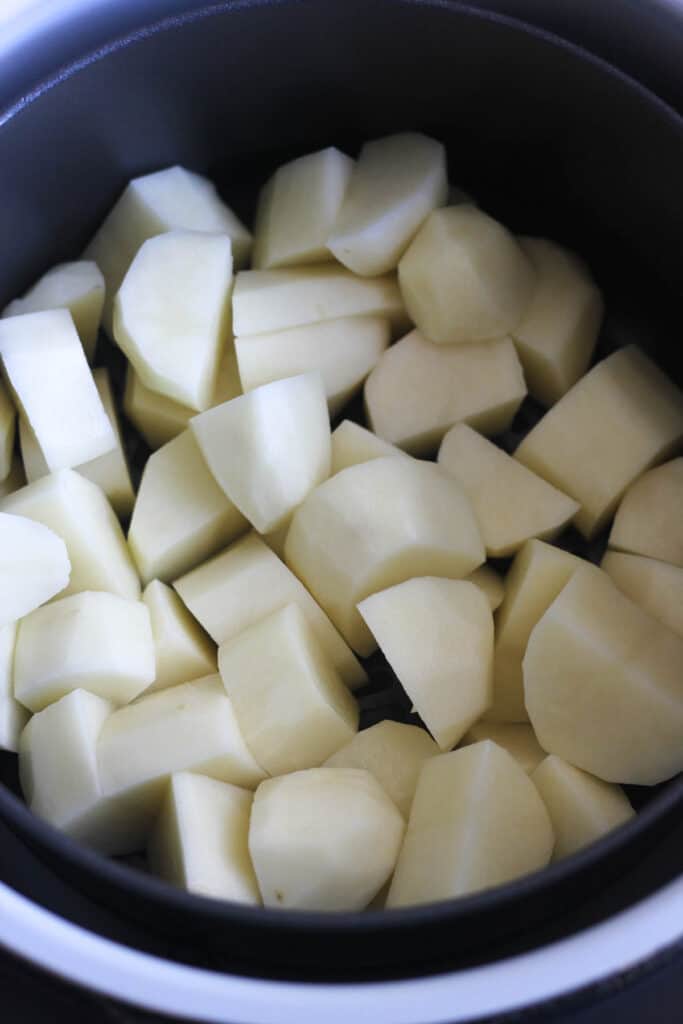 raw potatoes in the pressure cooker before cooking