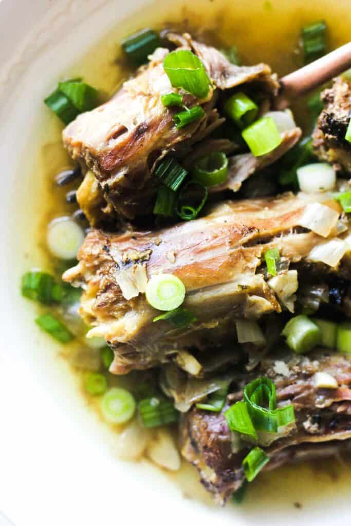 necks with chopped green onions with broth on the plate