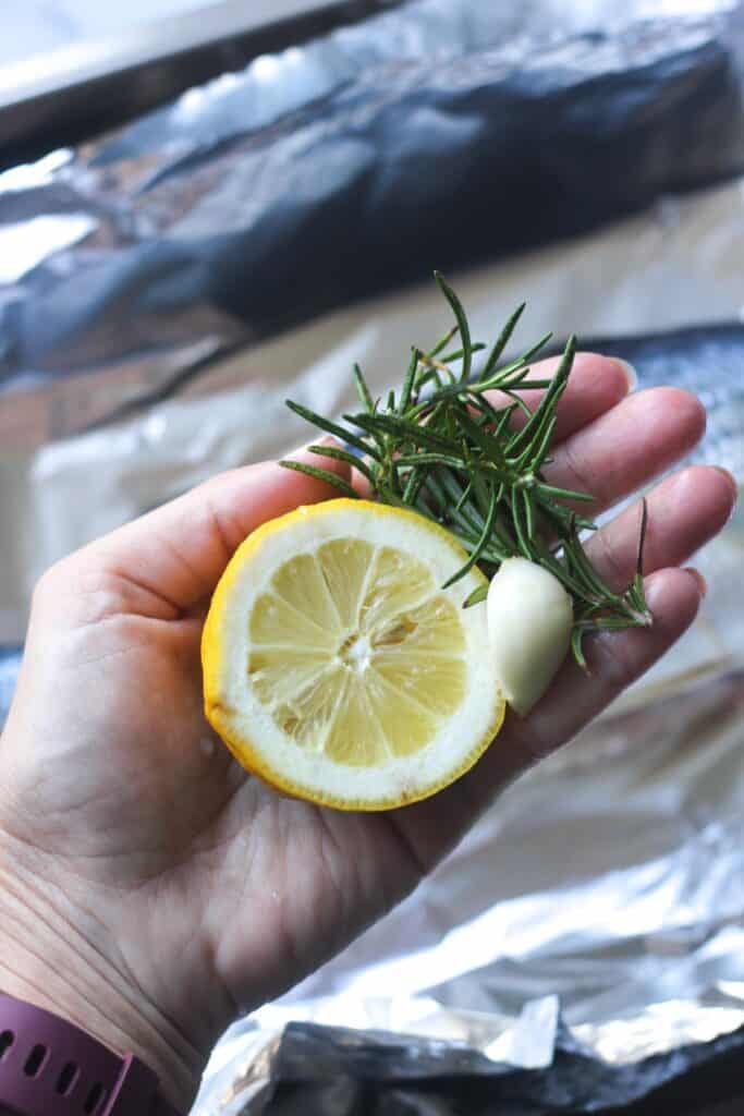 rosemary, lemon and garlic in the hand