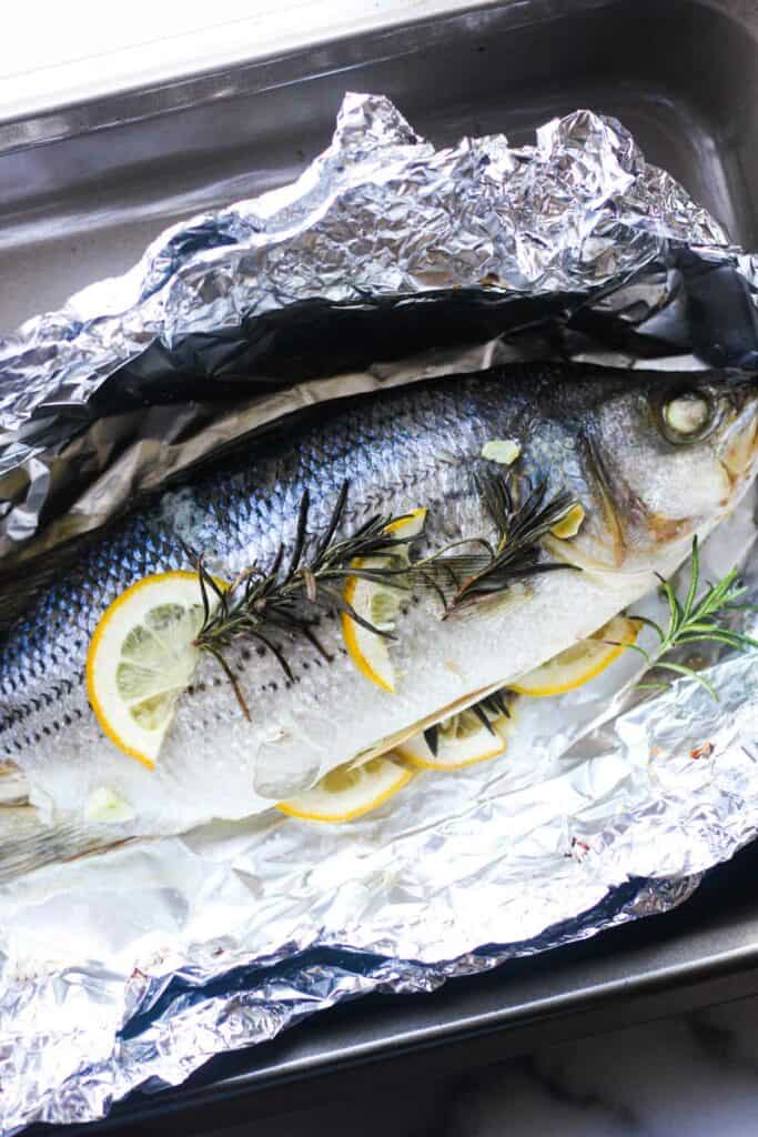 baked striped bass in foil with lemon , garlic and rosemary