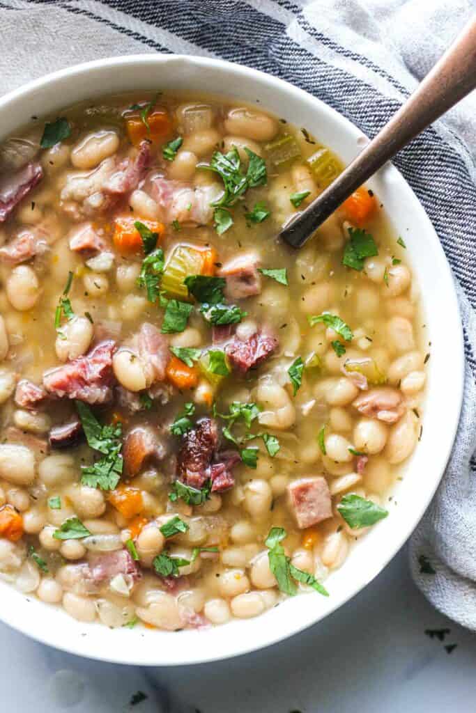 a bowl of ham soup with white beans