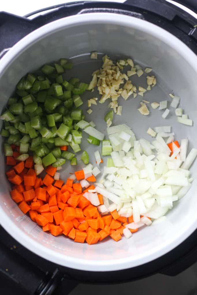 chopped garlic, cerely ribs, carrots and onions in the pressure cooker