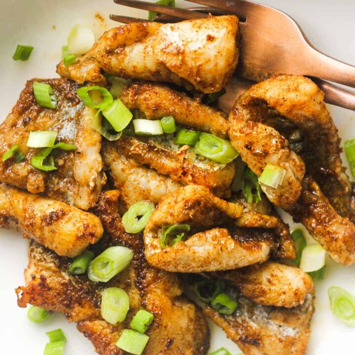 close look of cajun pan fried fish on a white plate