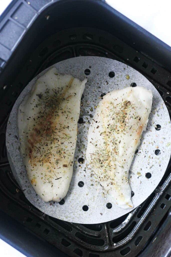 raw white fish fillets with spices in the air fryer
