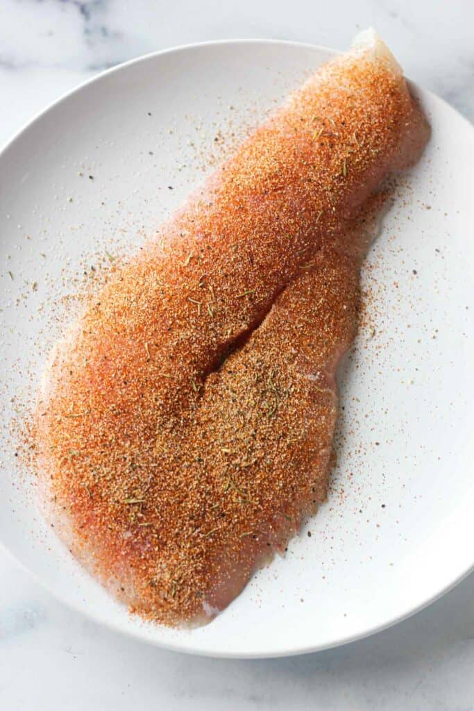 fish covered with spices on the plate