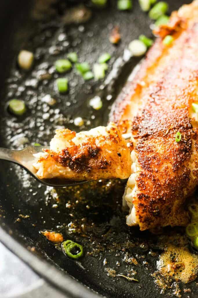 cooked tautog fish in the cast iron skillet