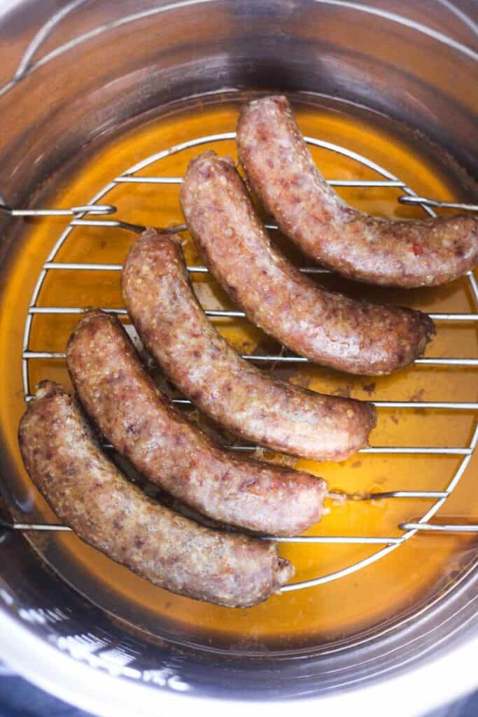 instant pot frozen sausage cooked and sitting on the trivet