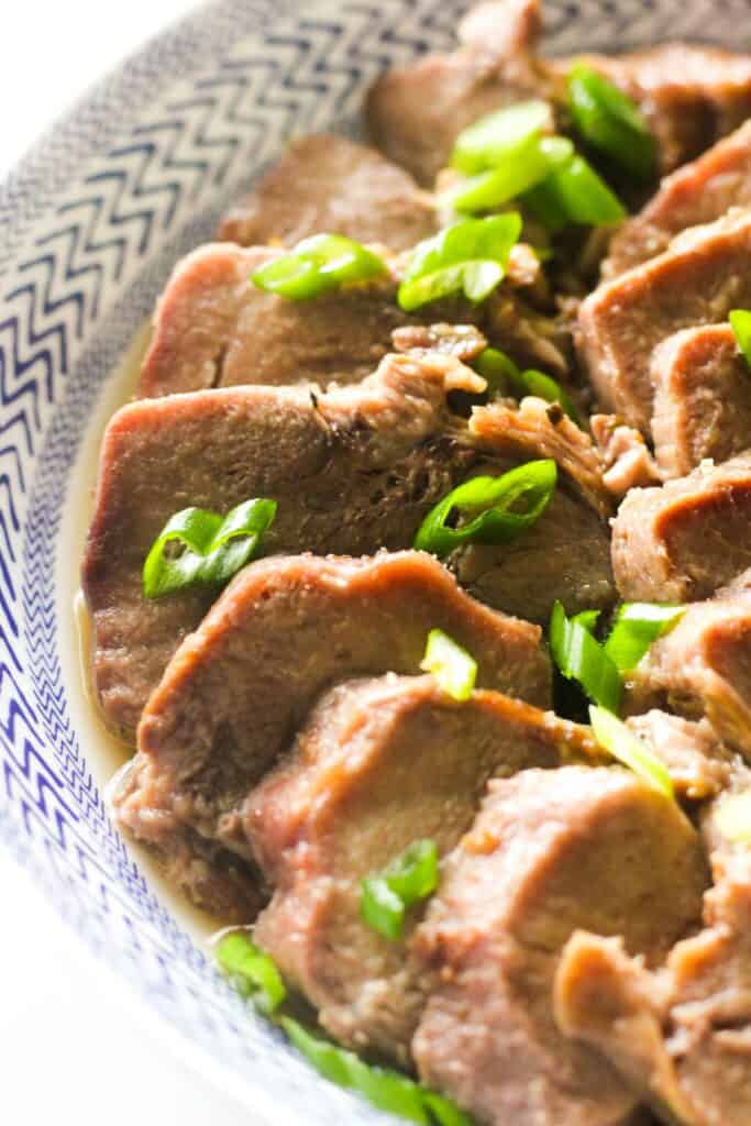 pork tongue cooked in instant pot with chopped green onions on top