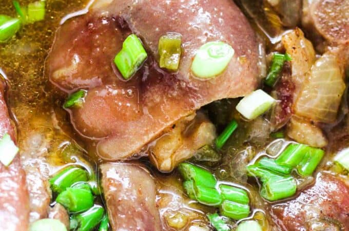 pig trotters cooked in slow cooker with green onions on top