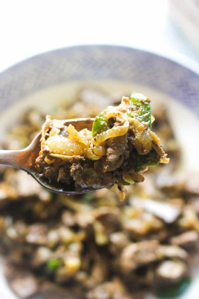 cooked lamb liver with onions in the spoon